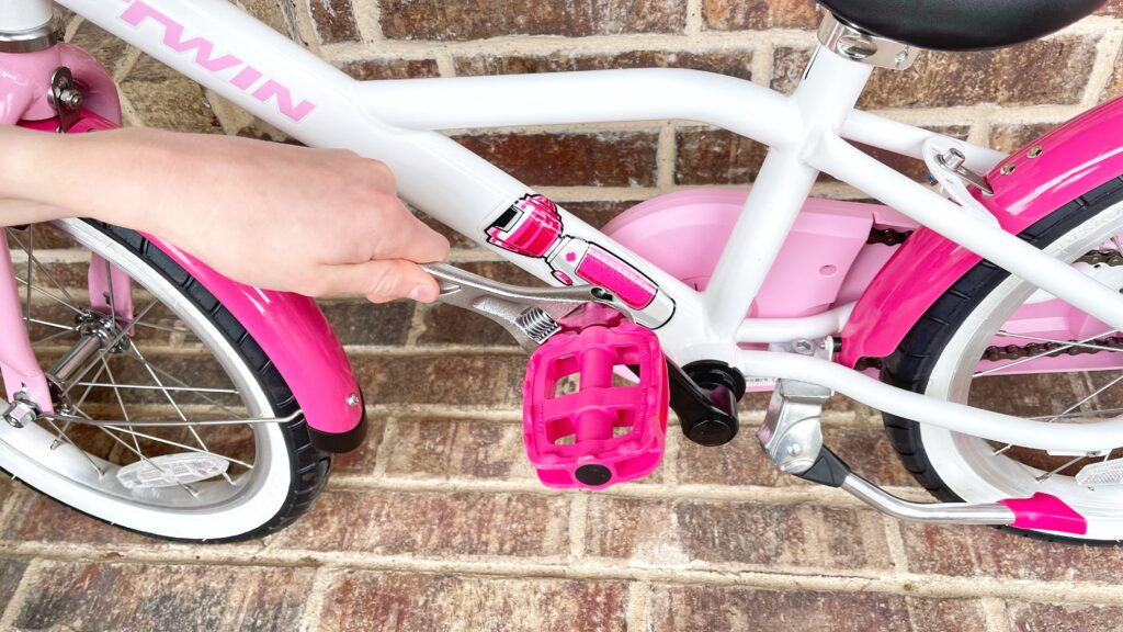 Tightening left pedal on kids bike to put it back on