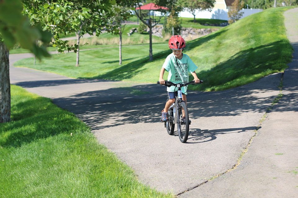 Boy climbing hill on Prevelo Alpha Three 20 inch bike