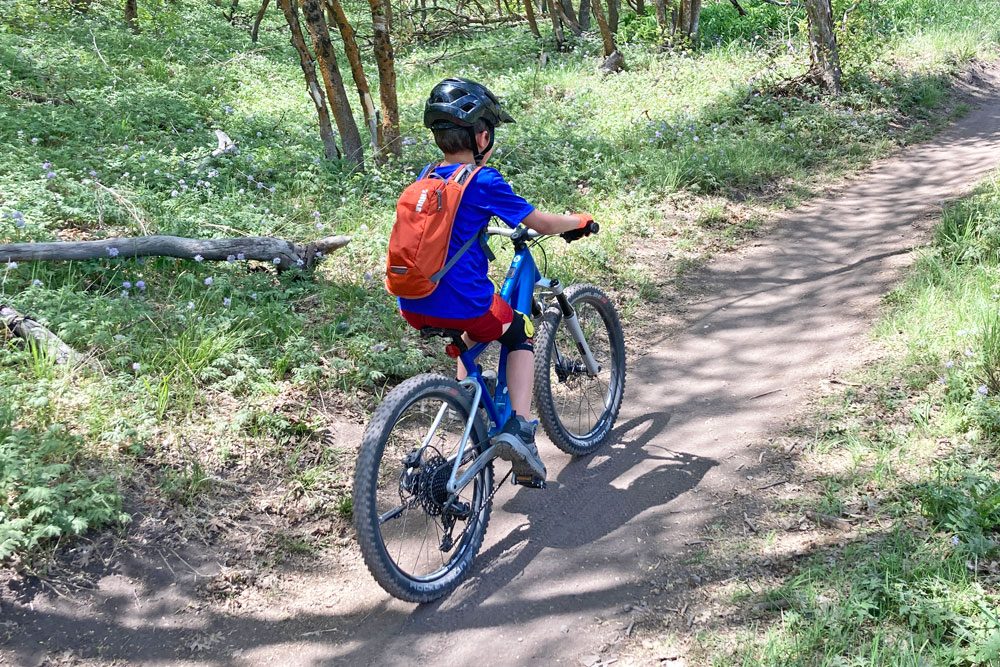 riding through the woods on the woom UP mountain ebike for kids