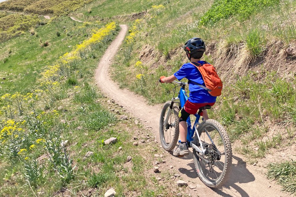 riding along a mountain bike trail on the woom UP ebike