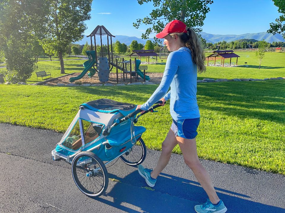 Mom pushing Qeridoo Speedkid 2 while walking