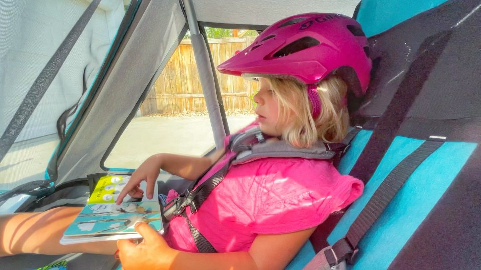 Toddler sitting in Qeridoo Speedkid, showing how helmet hits back of seat