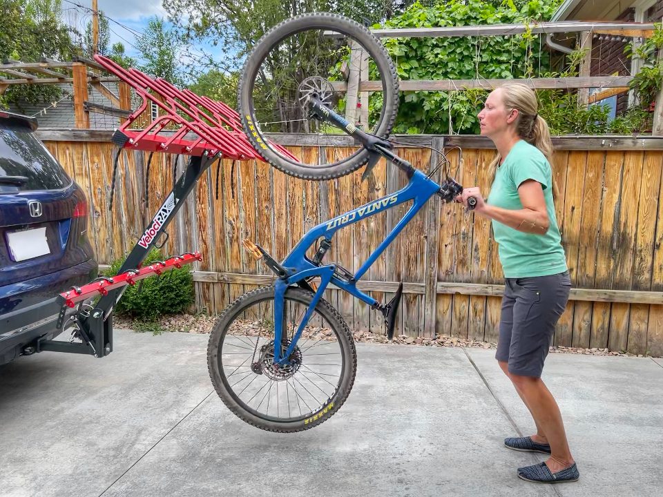 woman rolling 29 inch mounting bike into the tire hoop on Velocirax