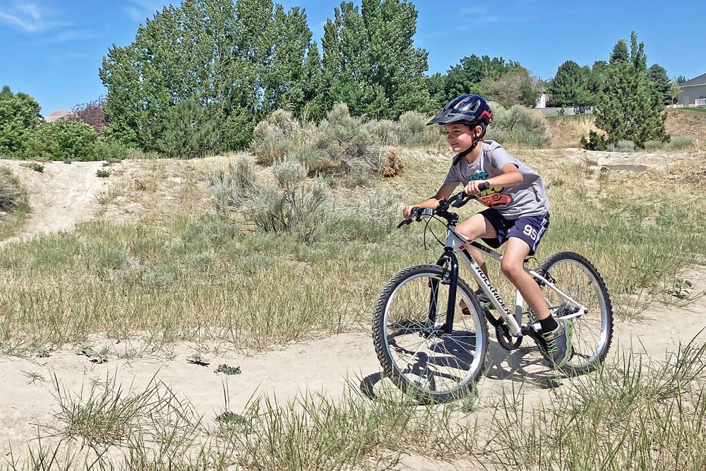 riding on a dirt path on the btwin rockrider 24