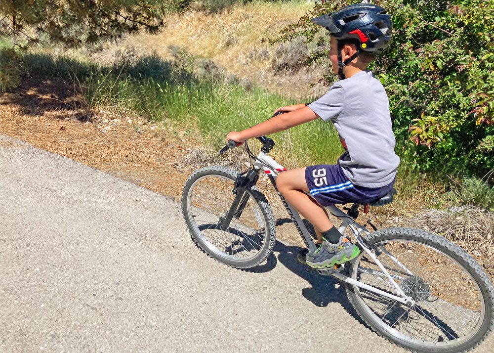 riding the btwin 24 kids bike on a paved bike trail