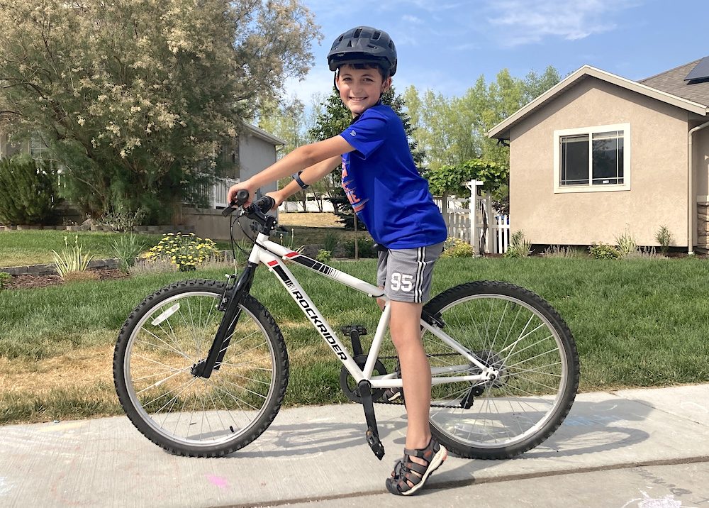 54" boy riding the Rockrider 24 inch bike