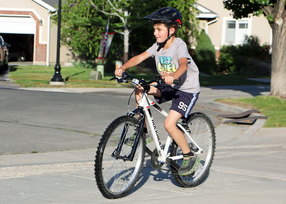 boy riding a btwin rockrider 24 inch kids bike