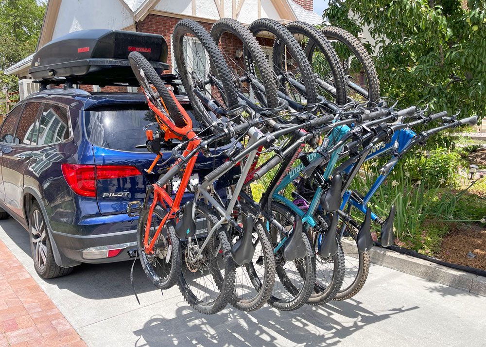 alta rack fully loaded with six bikes while in a drive way