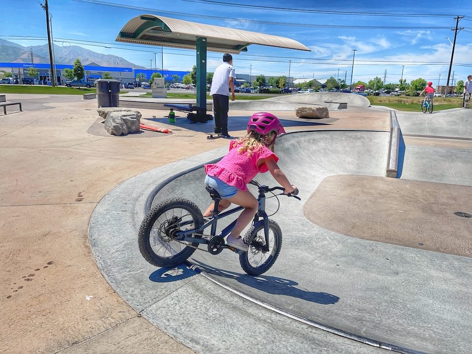 Child dropping into bowl at skatepark on Prevelo Zulu Two