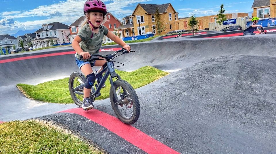 Child racing on Velosolutions pump track on her Prevelo Zulu Two