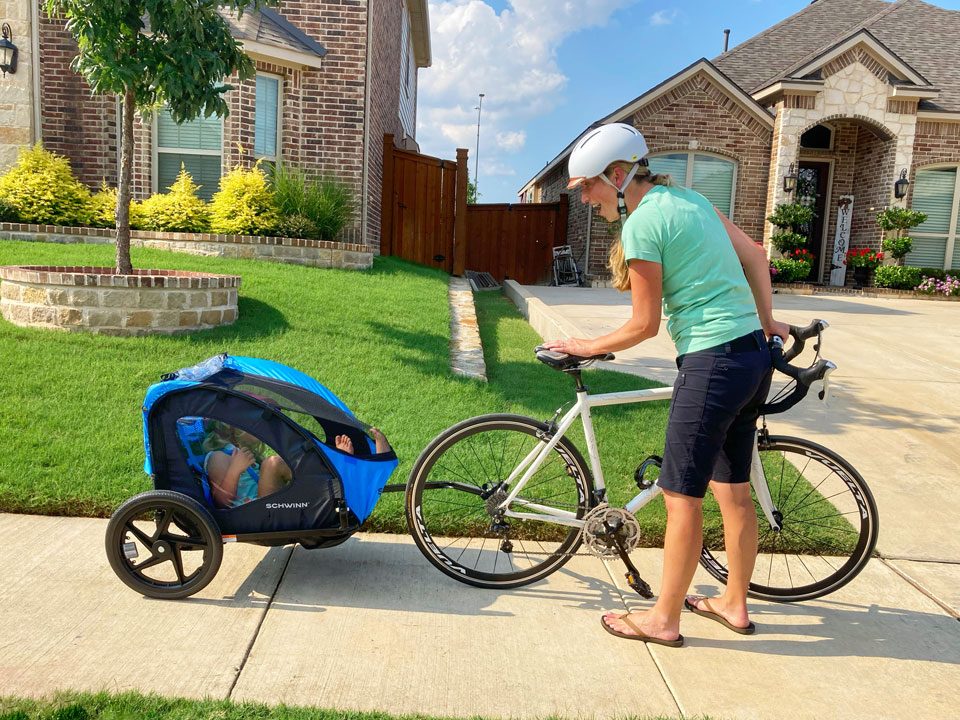 Mom talking to her baby in the Schwinn Shuttle foldable bike trailer