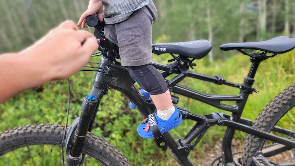 Child standing up in stirrups of Shotgun Pro MTB seat