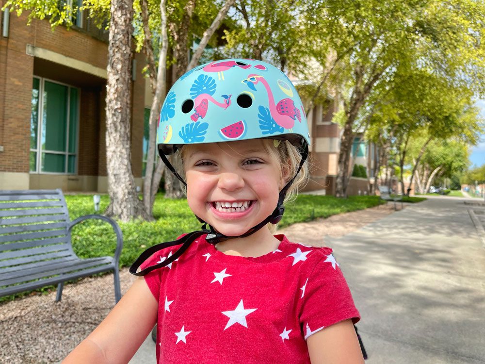 Child smiling while wearing the Hornit Mini Lid