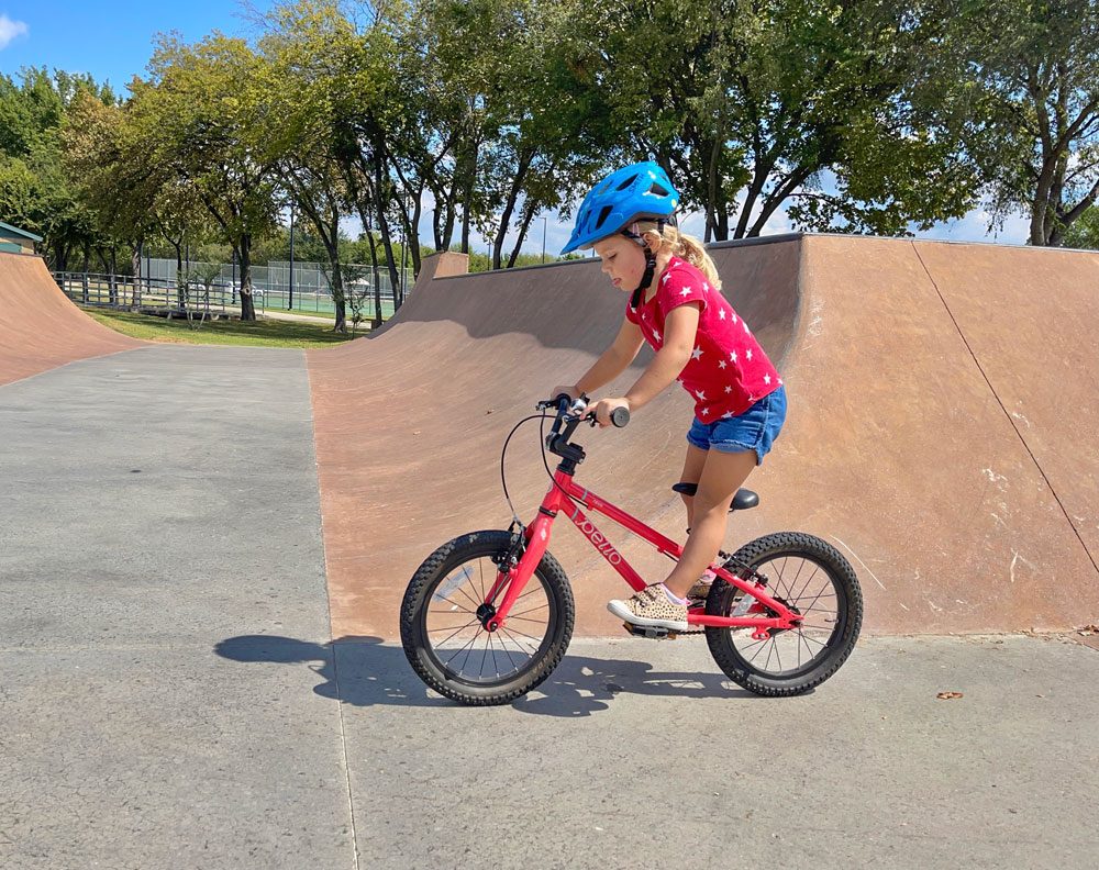 Child riding through skatepark wearing the Smith Wilder Jr kids bike helmet