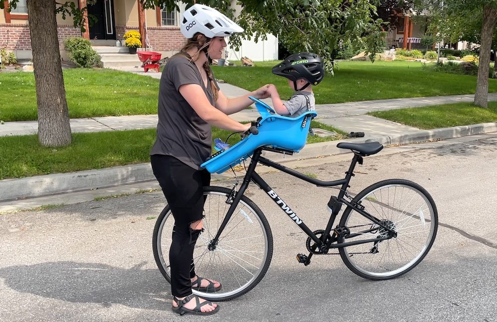 mom talking to her son while sitting in the ibert chid bike seat