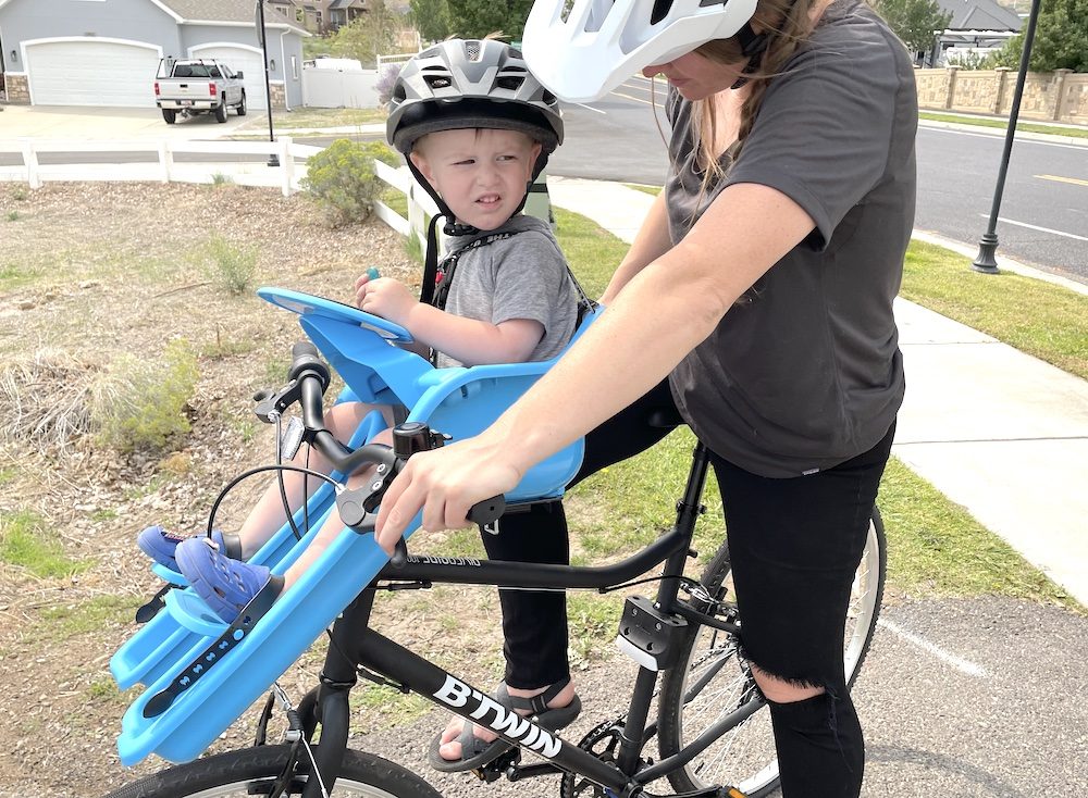 mom looking at her child sitting in the ibert bike seat