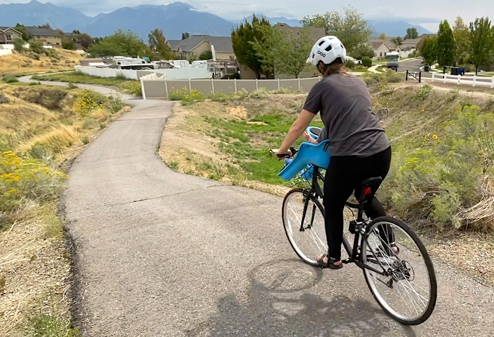 riding down a path with the ibert child bike seat