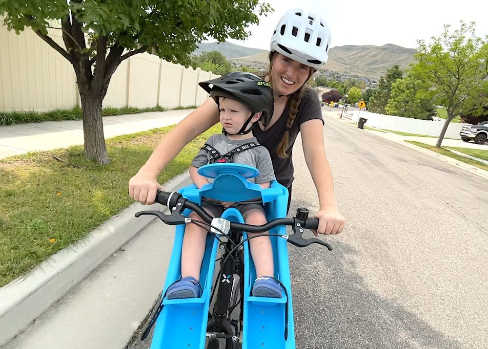 mom and son riding with the ibert front mounted seat