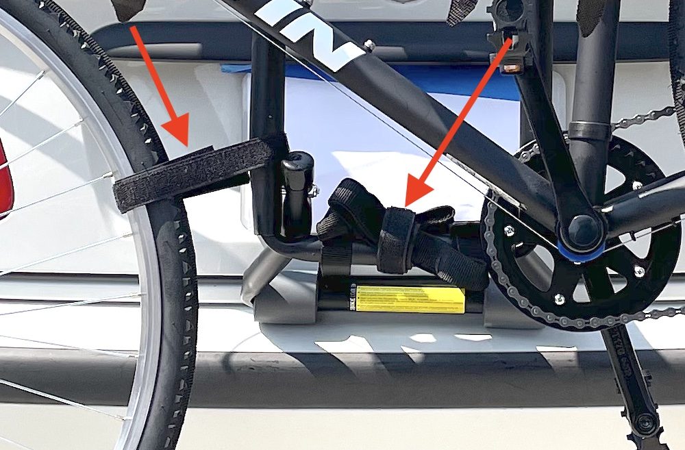Velcro straps attached to bike on trunk rack to prevent it from swaying