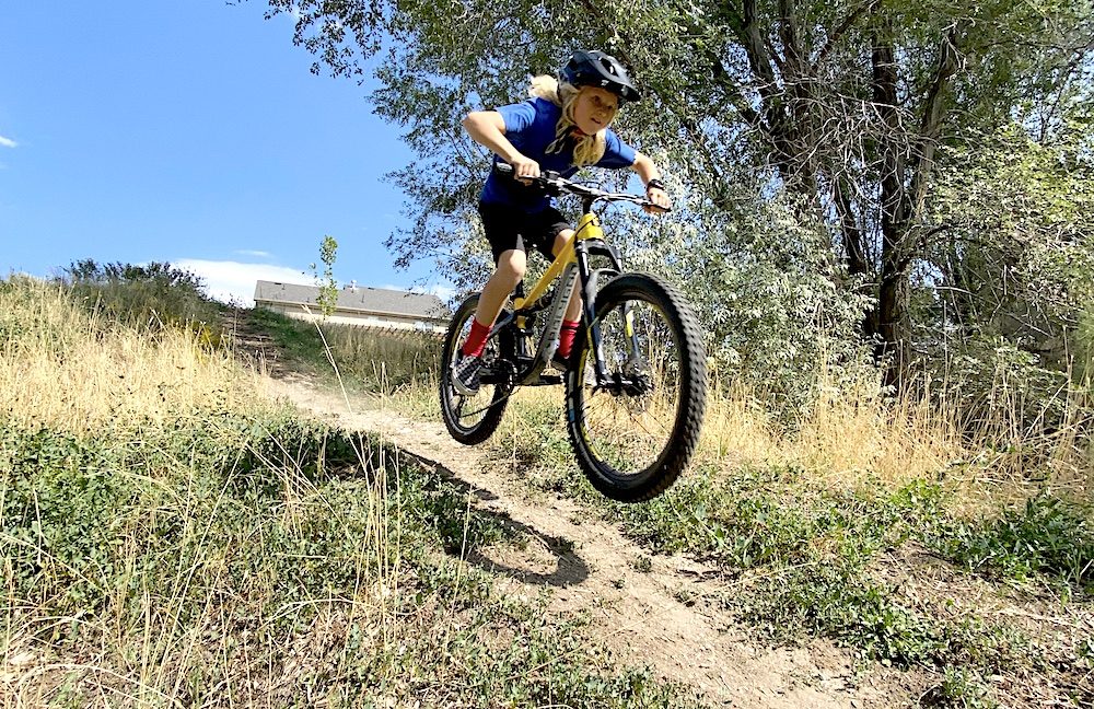 catching air off a jump on the polygon siskiu full suspension kids mountain bike