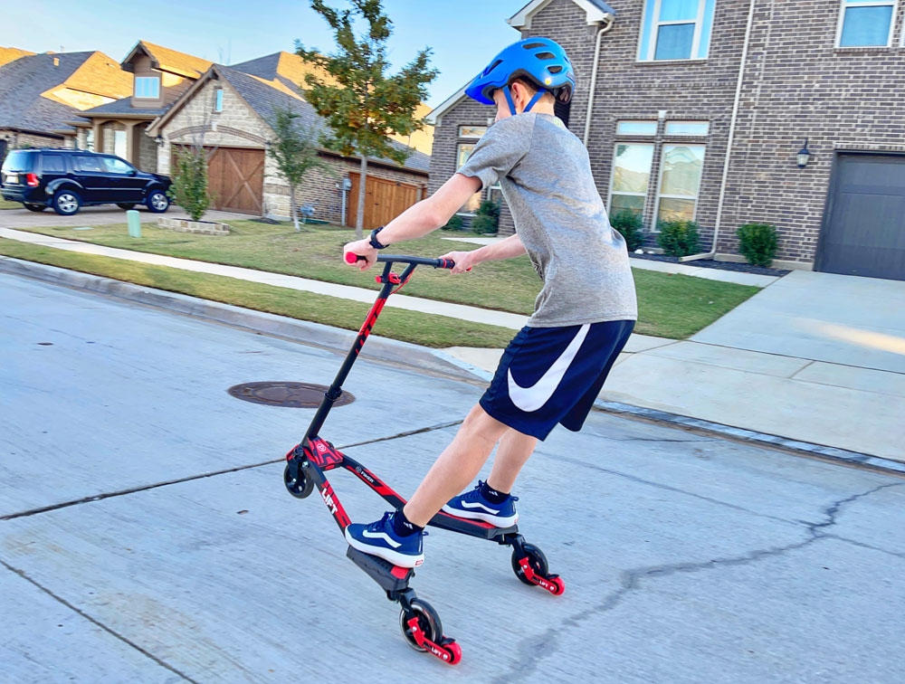 14 year old boy doing a wheelie on the Y Fliker LIFT wiggle scooter
