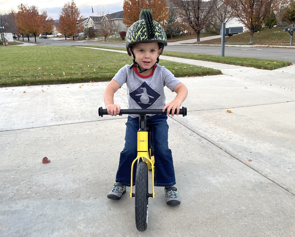 young boy holding onto the handlebars of the Hornit AIRO