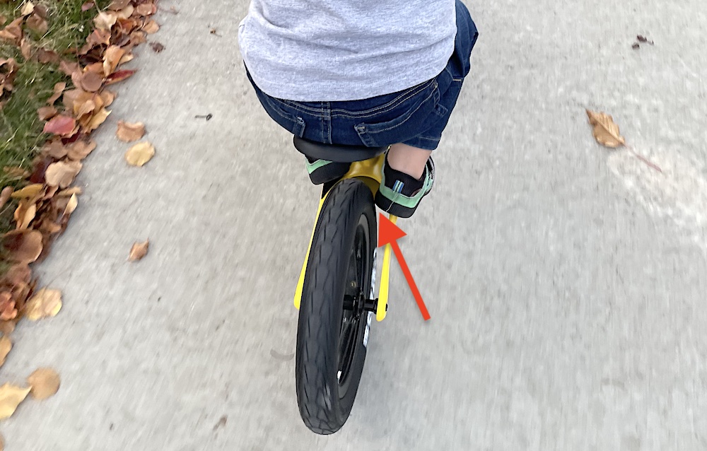 boys foot hitting the tire while using the footrest on the Hornit AIRO