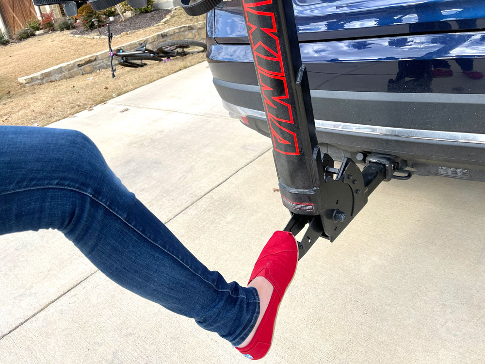 Pushing down on foot lever of Yakima HangTight to lower the mast for rear hatch access