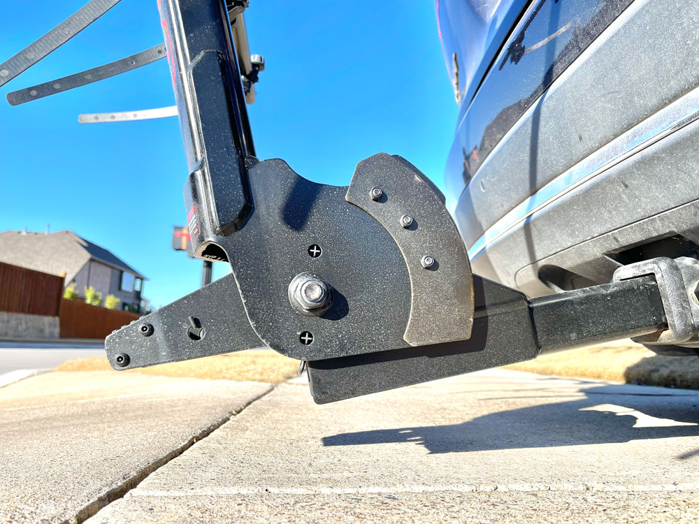 Minimal ground clearance of Yakima HangTight 6 capacity vertical bike rack on a low hitch vehicle in a steep driveway