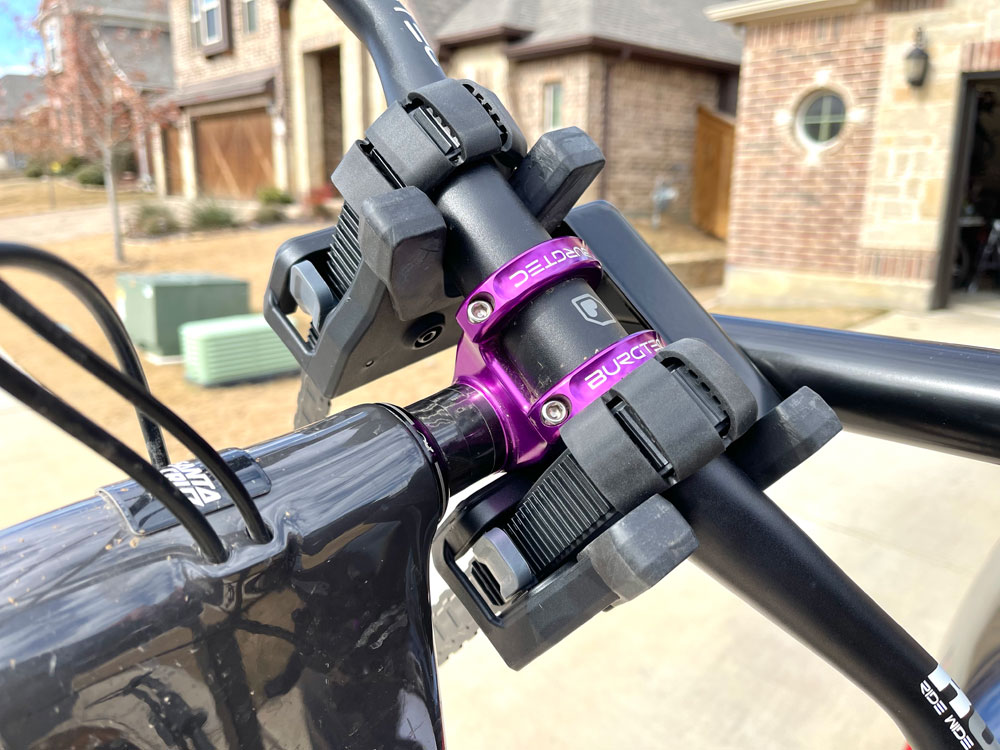 Up close shot of straps of Yakima HangTight pulled over handlebars of mountain bike