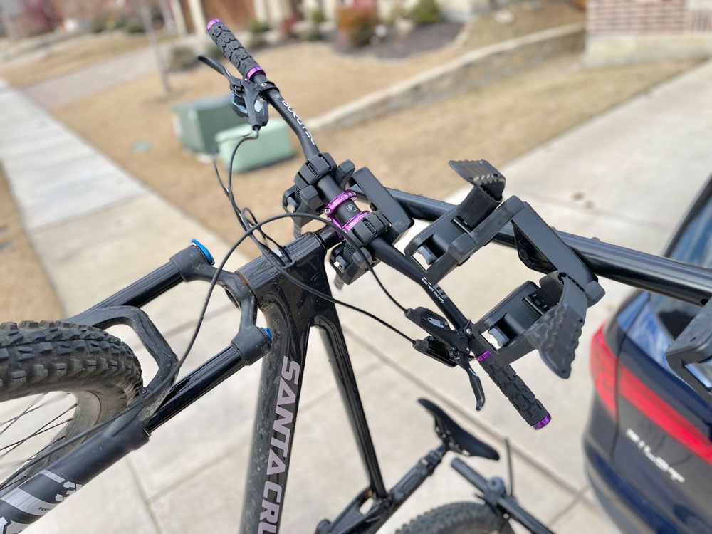 Bike hanging from its handlebars on Yakima HangTight 6 vertical hitch bike rack