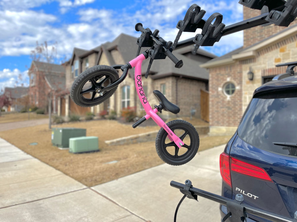 Balance bike hanging from the Yakima HangTight 6 capacity vertical bike rack
