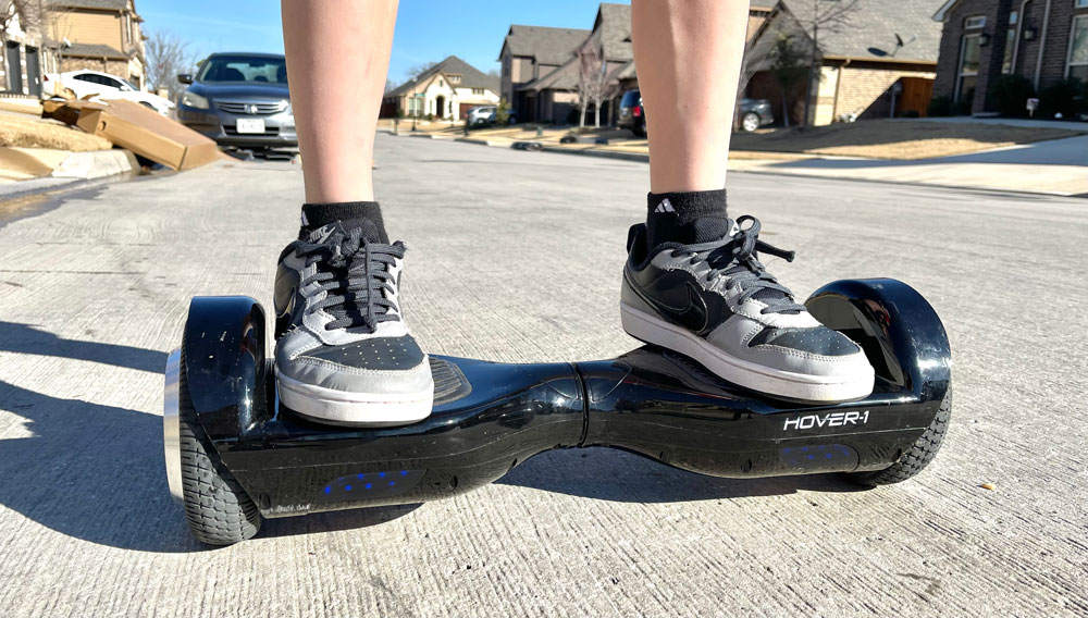Boy riding Hover 1 hoverboarrd in the street