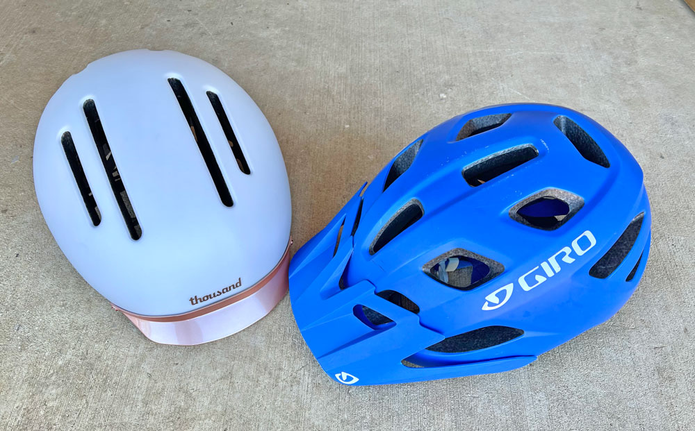 Womens commuter helmet and womens mountain bike helmet side by side, showing how the mountain bike helmet has more vents