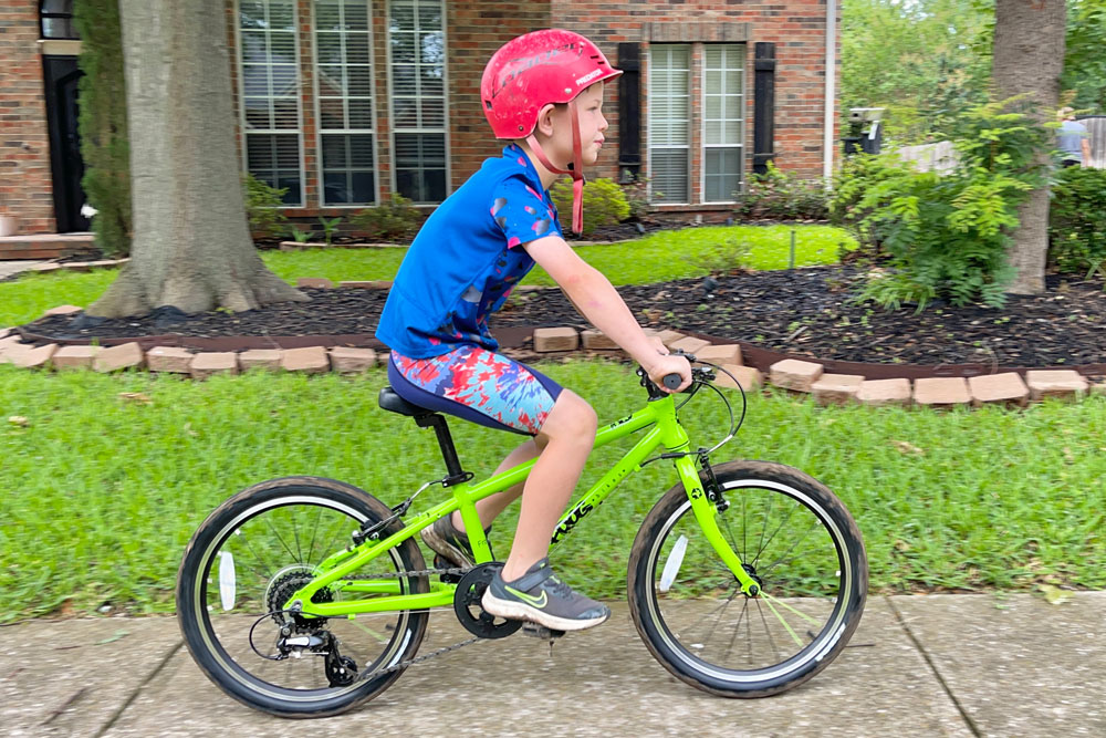 7 year old riding Frog 52, showing how taller child fits on the bike