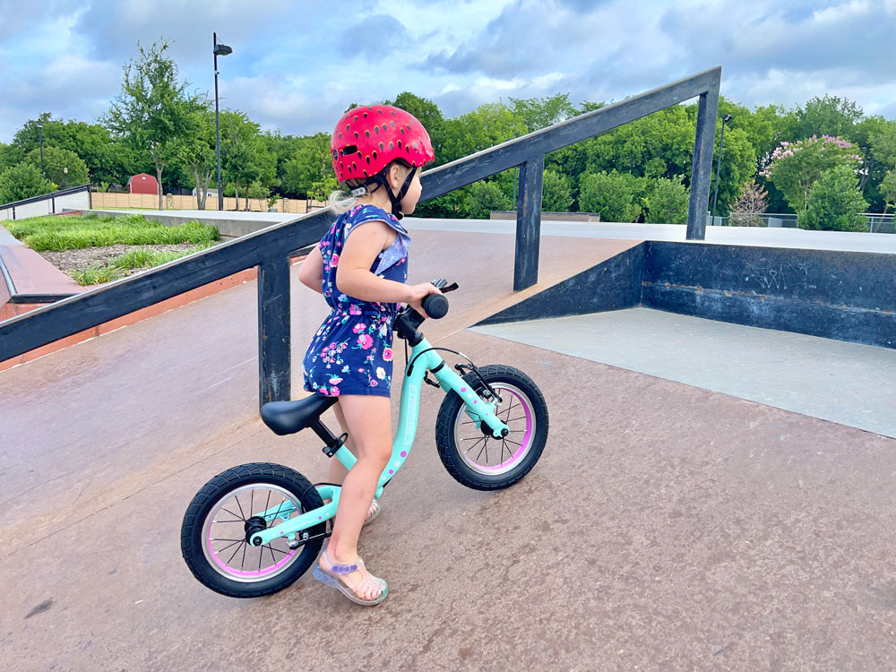 Toddler riding Guardian balance bike up a ramp