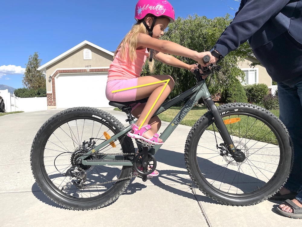 young rider on the Commenal Ramones 24 showing the struggle to pedal due to a high pedal stroke