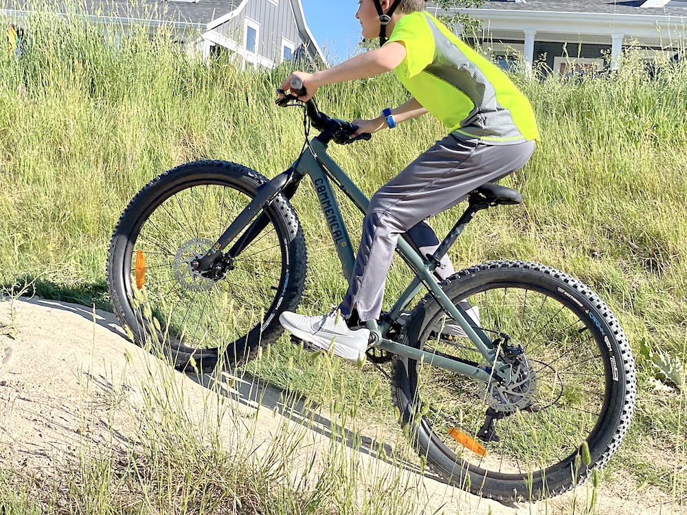 10 year old riding the commencal ramones 24 up a hill - image showing the short chainstay of the Ramones