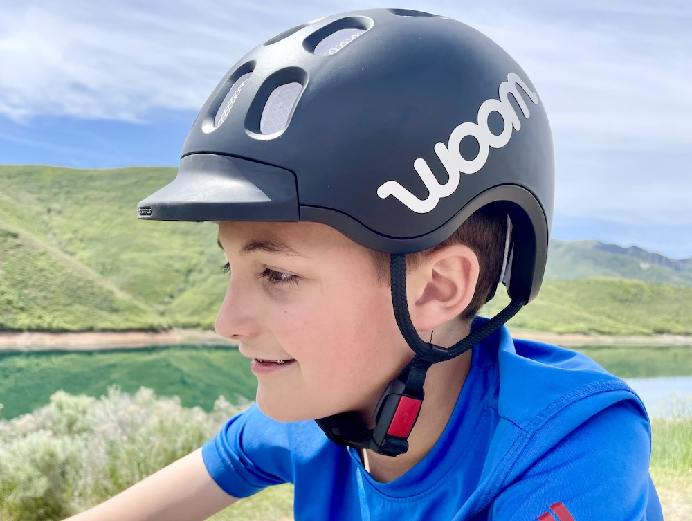 Boy wearing black woom kids helmet