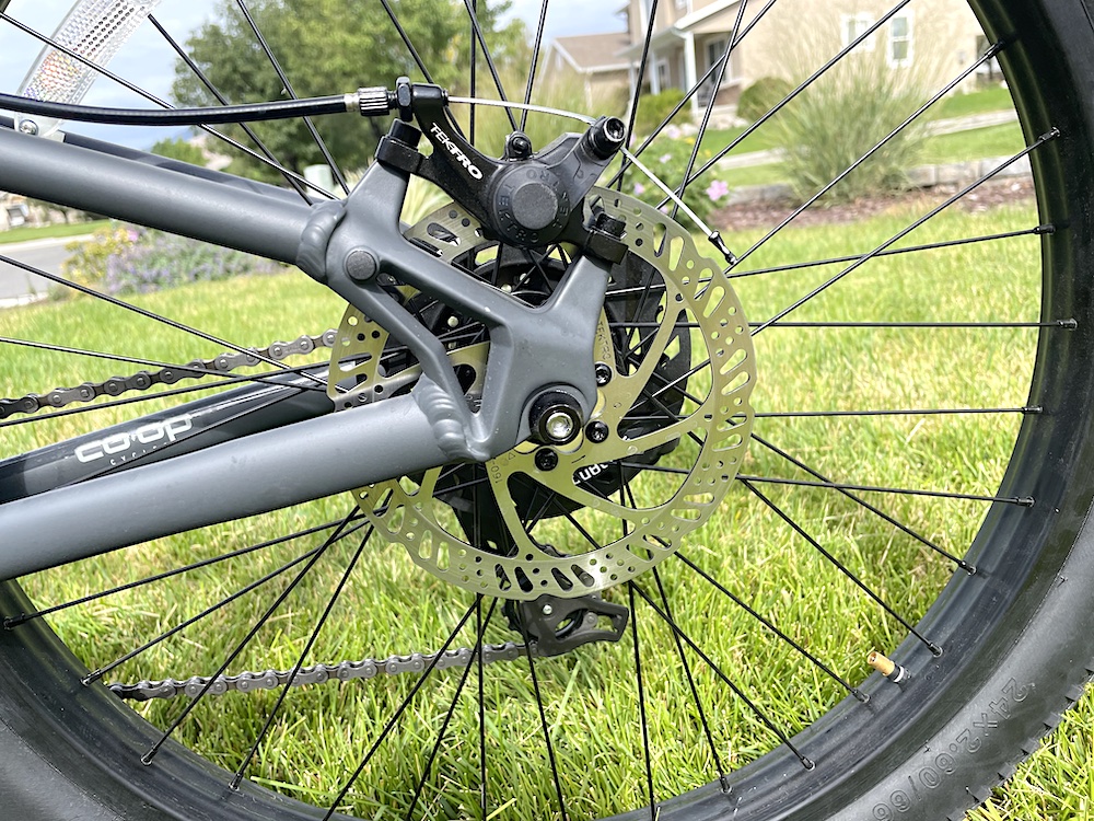 Close up image of the Tektro 160 mm rotor on the rear tire of the REI REV 24" kids bike