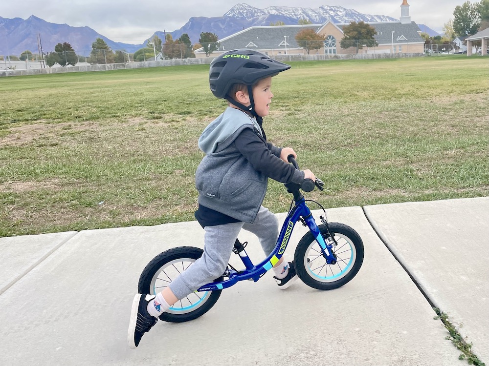 guardian balance bike ridden by an older toddler on a sidewalk