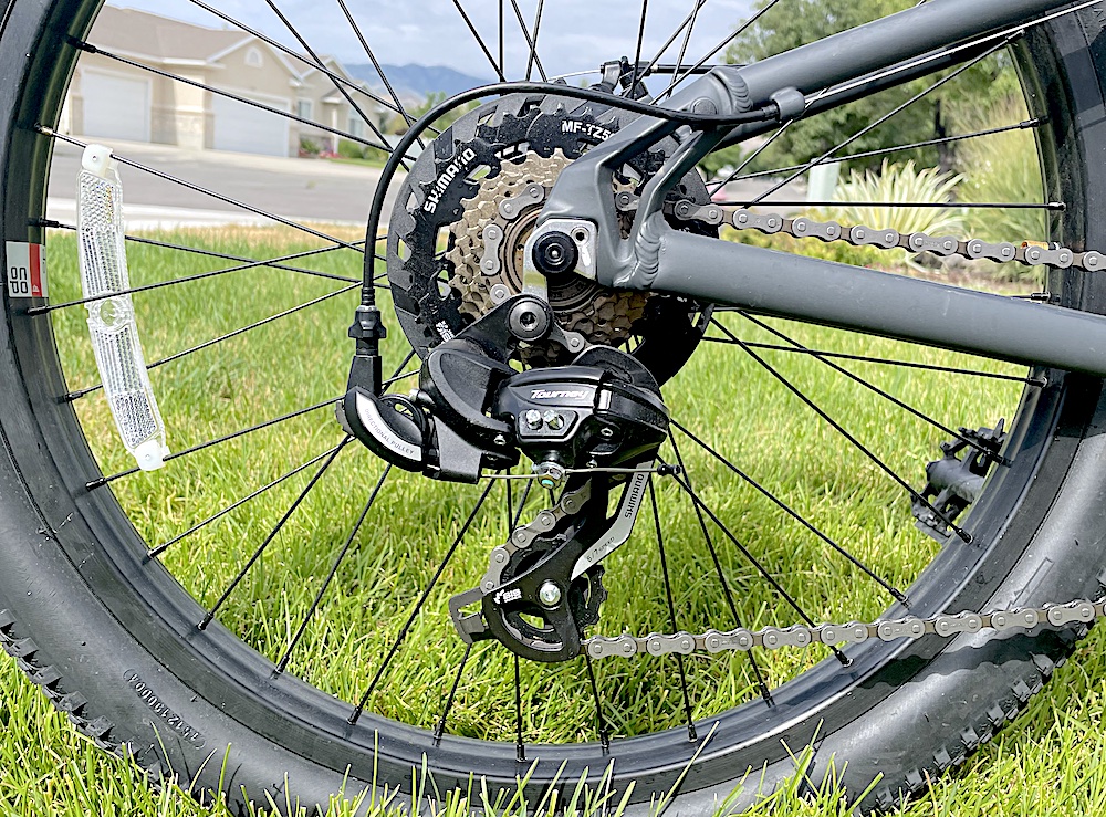 Close up image of the cassette and Shimano Tourney derailleur on the REI REV 24" kids mountain bike