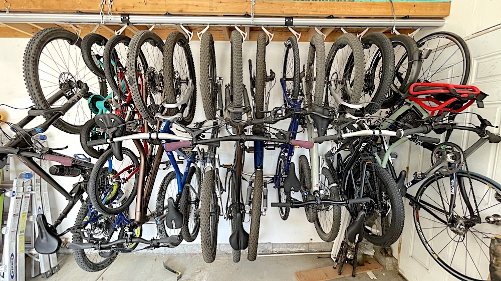 stashed storage vertical ceiling bike rack loaded with lots of bikes