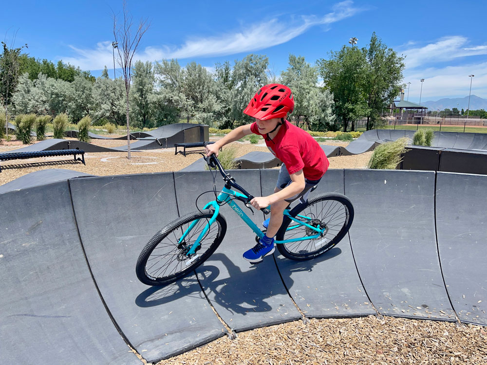 Boy riding Pello Roovi on a modular pump track