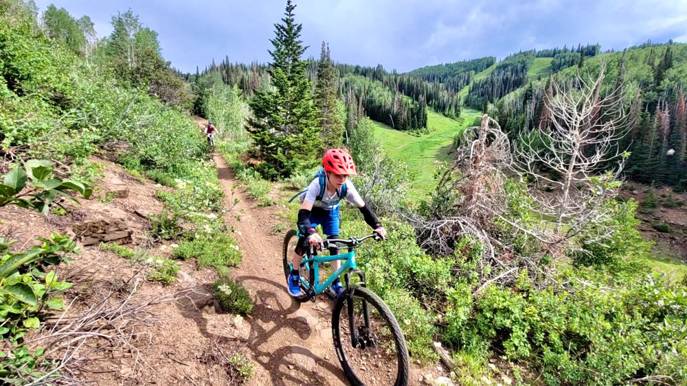 Boy riding Pello Roovi on downhill trail in Park City