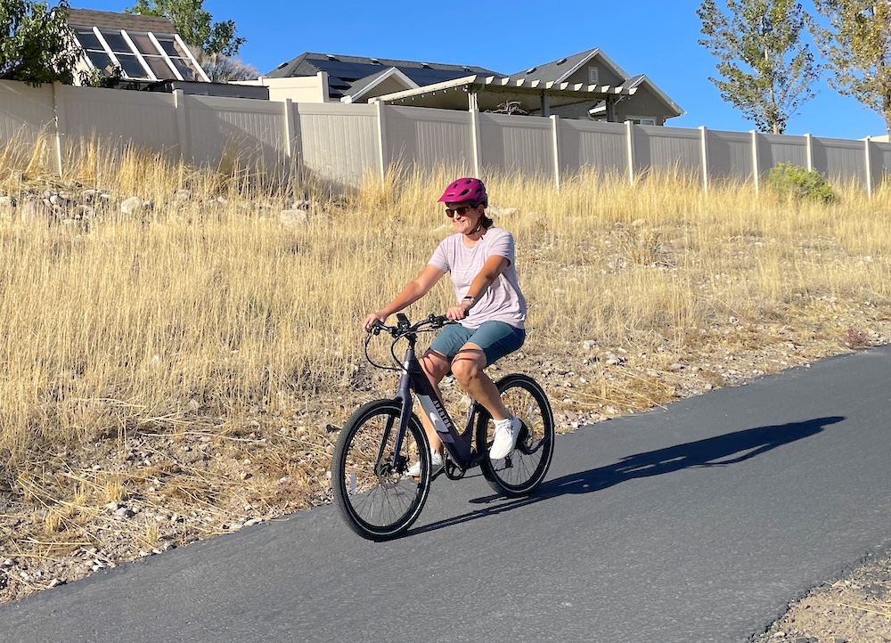 Riding the Aventon Pace 350 on a paved bike trail