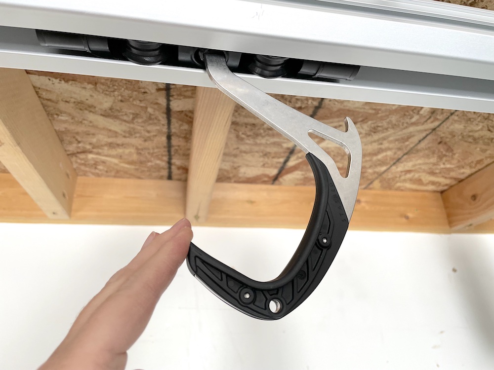 hand pushing on SpaceRail hook showing how it locks into place when not loaded