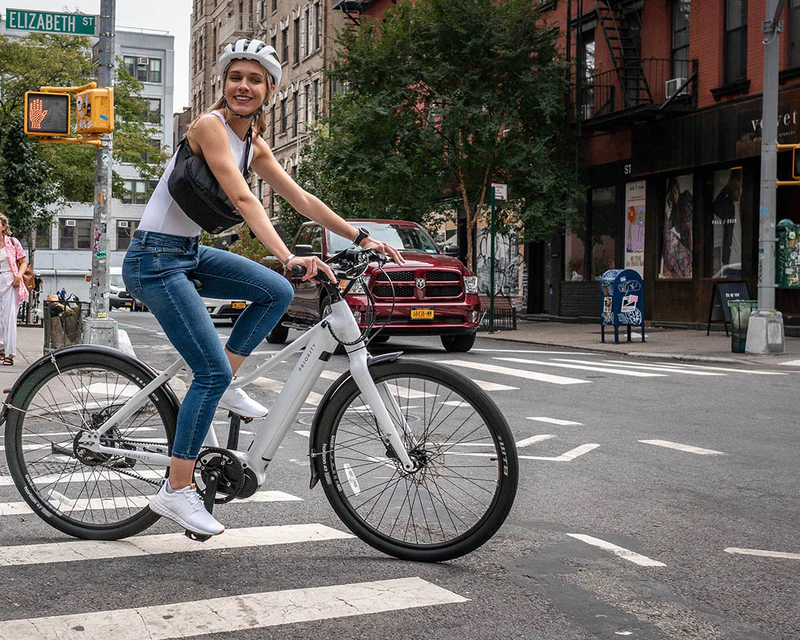 women riding the priority current electric bike