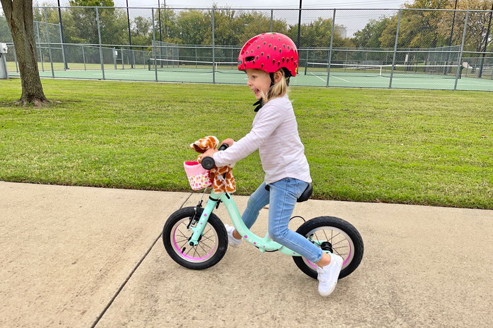 young girl riding the Guardian balance bike