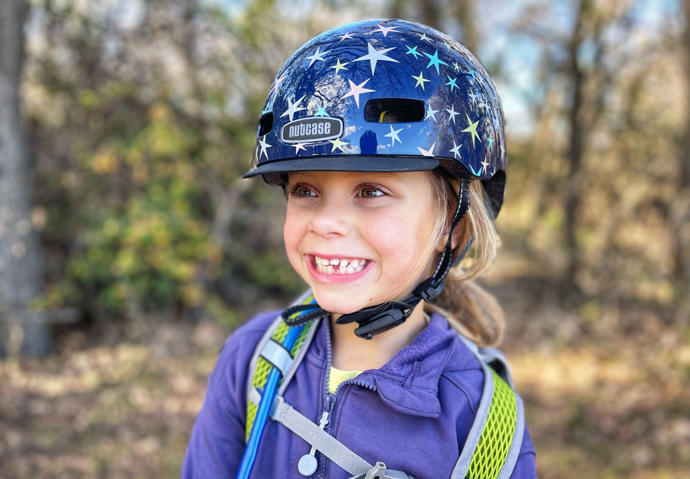 5 year old girl wearing Nutcase Little Nutty youth size helmets with star pattern